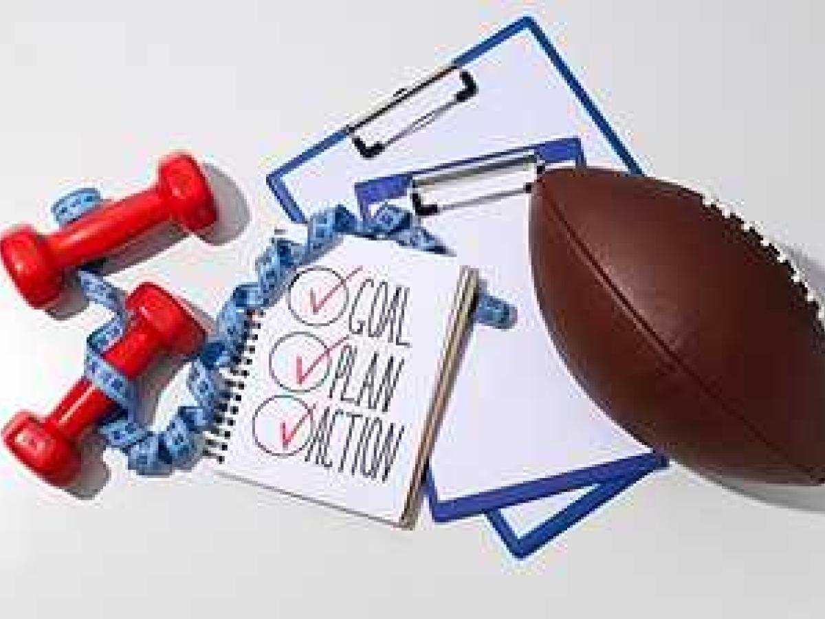 Image of weights, clip boards, and a football with text of goal, plan, and action.